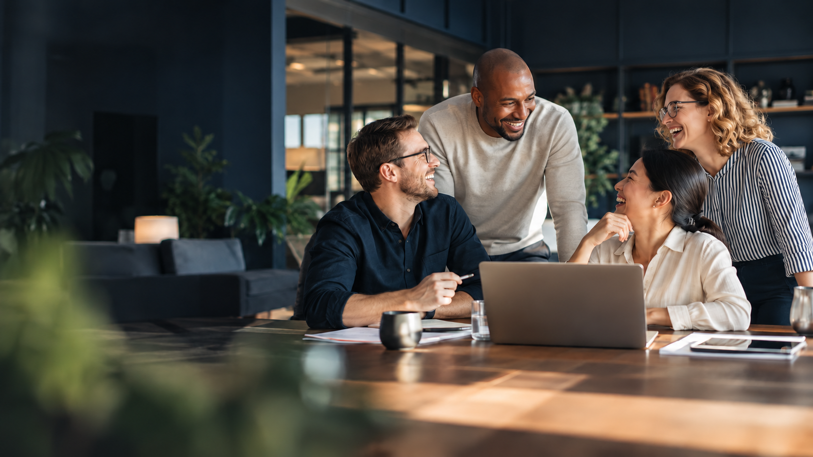 Colleagues collaborating and sharing a laugh in a modern office