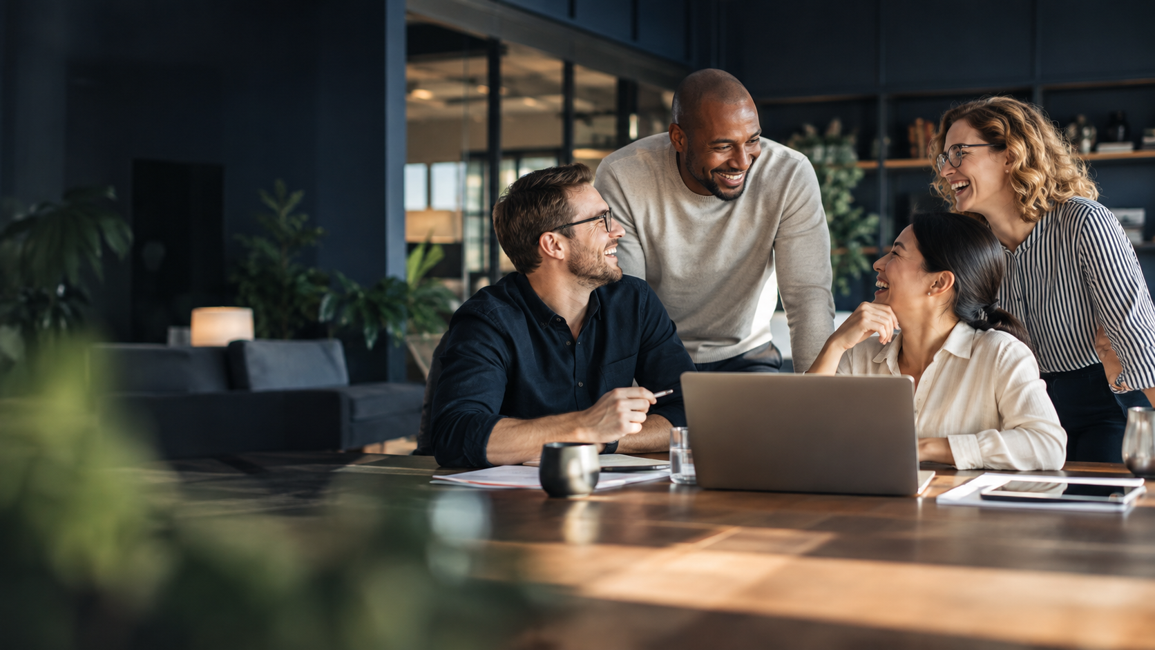 Colleagues collaborating and sharing a laugh in a modern office